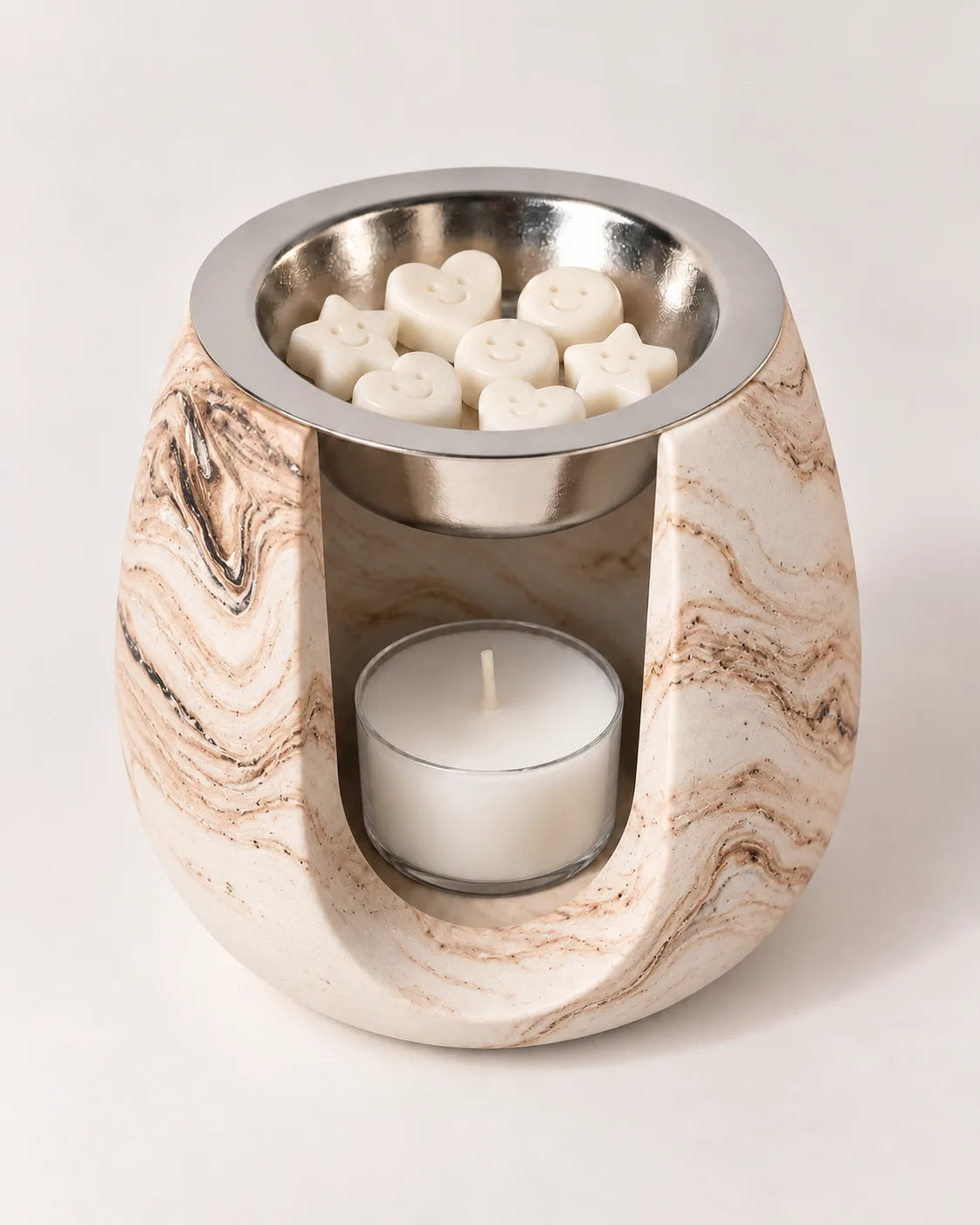 Quemador ZAEVA Onda de resina marmoleada con wax melts en el plato y vela de té